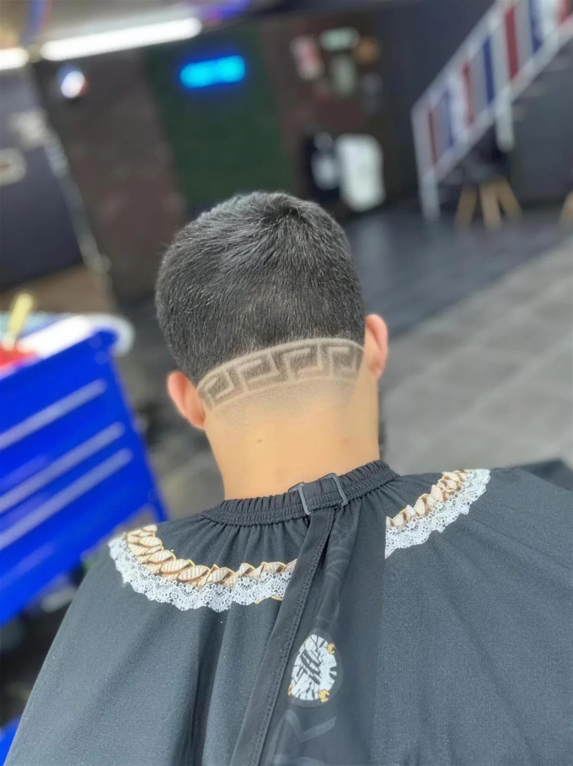 Greek-key freestyle design cut at House of Fadez